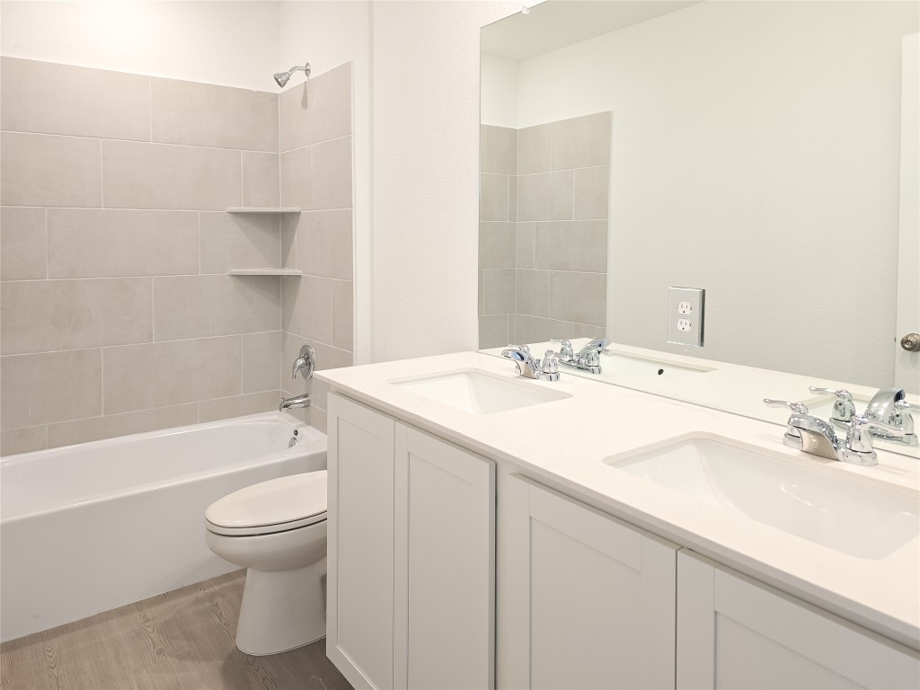 1117 Nesting Bird Drive Georgetown, TX 78628 - Photo 9 of 20 a bathroom with a granite countertop sink toilet and shower