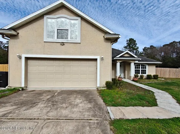 a front view of a house with a yard and garage