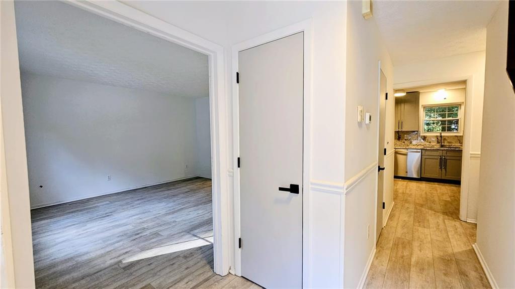 10505 Ash Rill Drive Alpharetta, GA 30022 - Photo 2 of 57 a view of a hallway with wooden floor and a living room