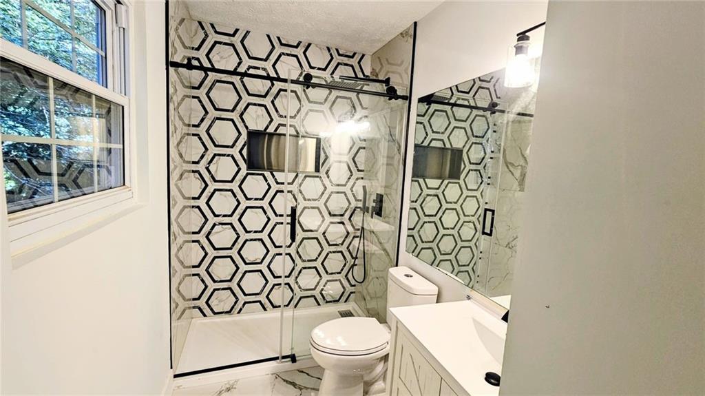 10505 Ash Rill Drive Alpharetta, GA 30022 - Photo 43 of 57 a bathroom with a toilet and shower curtain