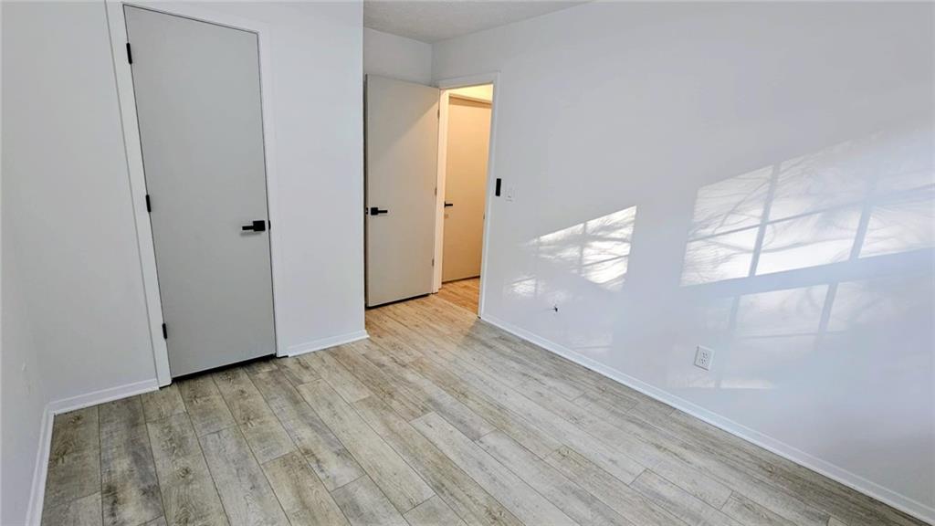 10505 Ash Rill Drive Alpharetta, GA 30022 - Photo 47 of 57 a view of an empty room with wooden floor and windows