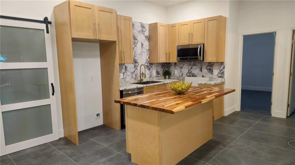10505 Ash Rill Drive Alpharetta, GA 30022 - Photo 55 of 57 a kitchen with a stove and a microwave