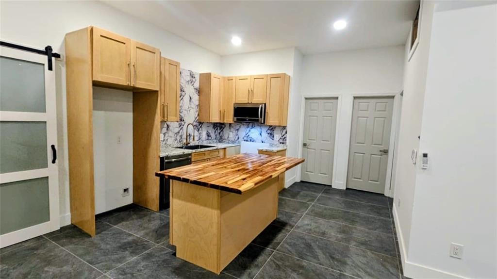 10505 Ash Rill Drive Alpharetta, GA 30022 - Photo 6 of 57 a kitchen with stainless steel appliances granite countertop a refrigerator and a stove