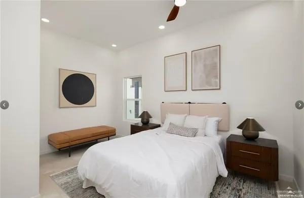 a bedroom with bed and a large mirror