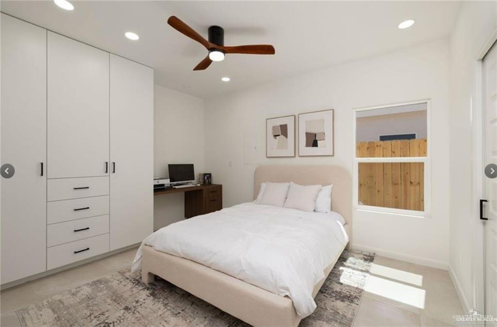 1502 Samara Avenue, Unit 2 Pharr, TX 78577 - Photo 10 of 11 a bedroom with a large bed and a chandelier