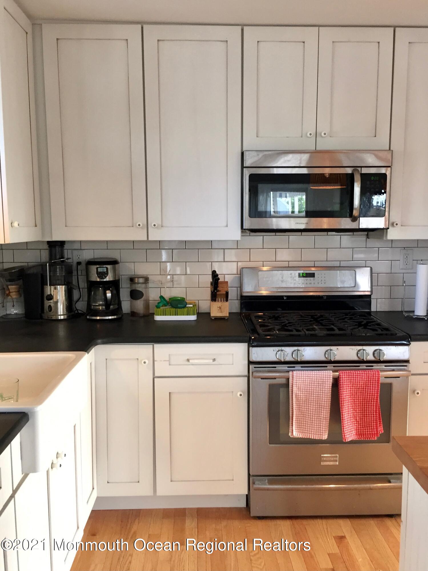 124 Gary Road Toms River, NJ 08753 - Photo 8 of 18 a kitchen with stainless steel appliances granite countertop a stove and white cabinets