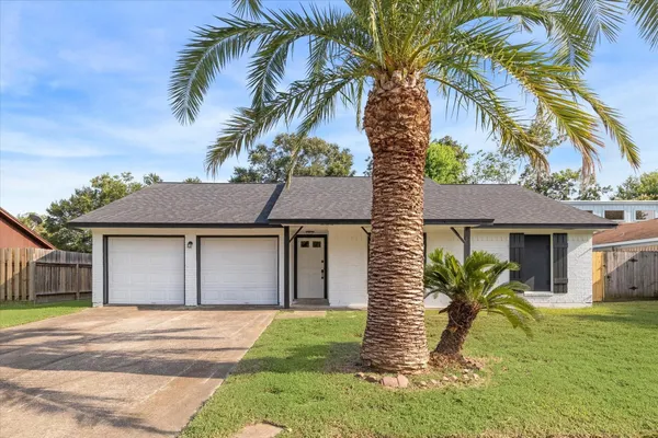 a house that has a tree in front of it
