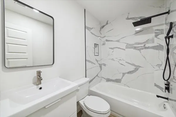 a bathroom with a sink toilet and shower