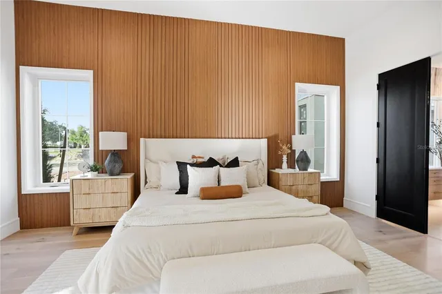 a spacious bathroom with a double vanity sink a mirror and a bathtub