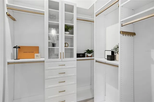 a bedroom with a bed and a television