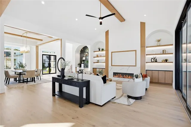 a living room with furniture potted plant and a large window