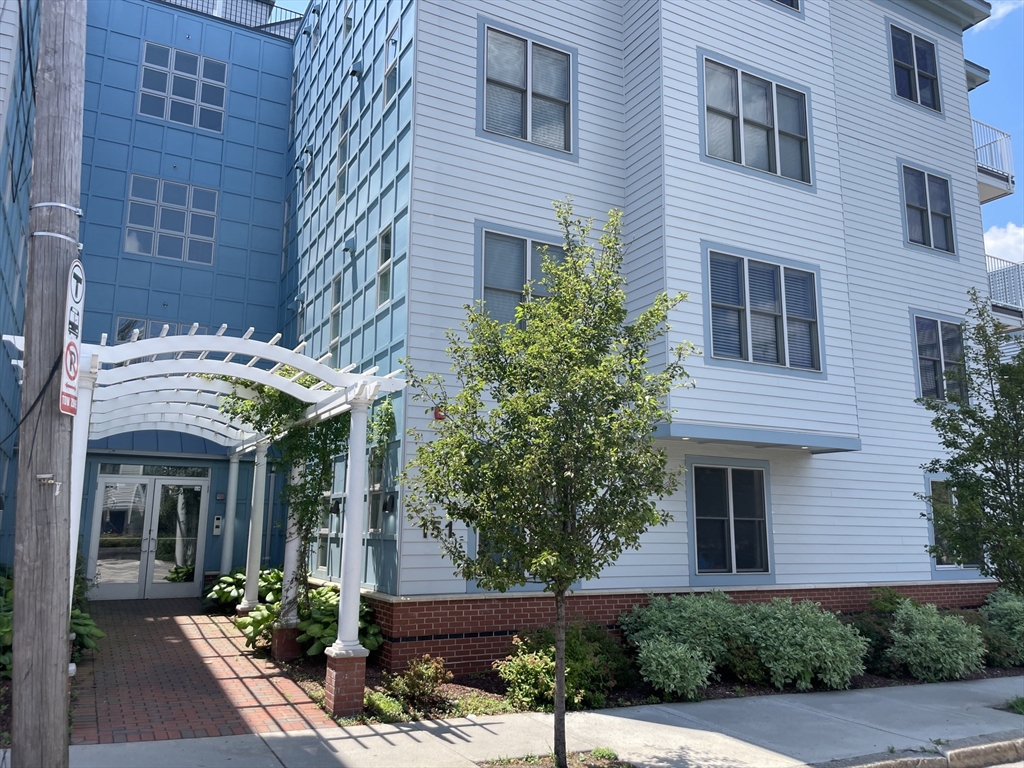 151 Hancock Street, Unit 5 Quincy, MA 02171 - Photo 2 of 12 a view of a brick building plants and large tree