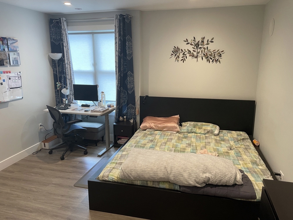 151 Hancock Street, Unit 5 Quincy, MA 02171 - Photo 5 of 12 a bedroom with a bed and a table in it