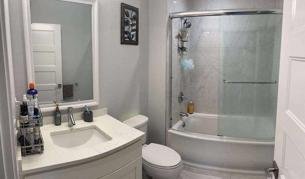 151 Hancock Street, Unit 5 Quincy, MA 02171 - Photo 8 of 12 a bathroom with a sink toilet and shower