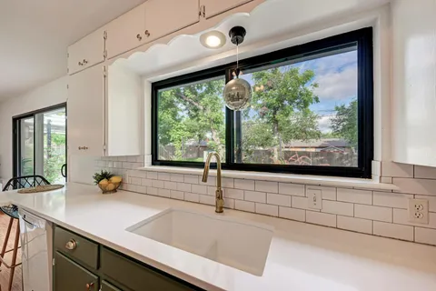 a kitchen with a sink and large window
