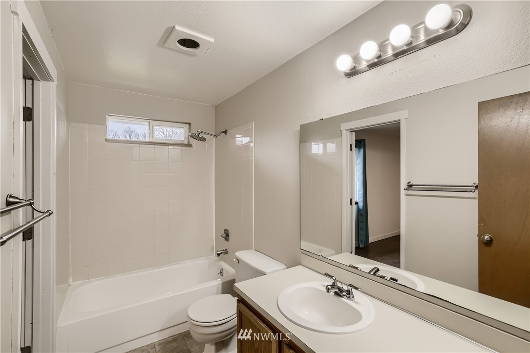 5445 17th Avenue Southwest Seattle, WA 98106 - Photo 11 of 19 a bathroom with a sink a toilet and shower