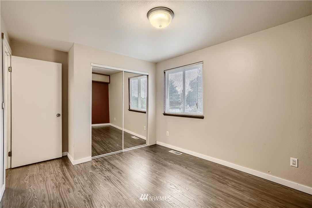 5445 17th Avenue Southwest Seattle, WA 98106 - Photo 13 of 19 an empty room with wooden floor and windows