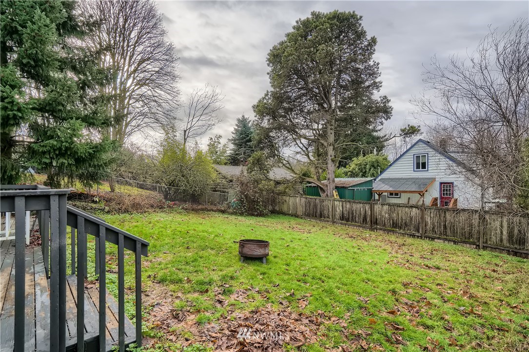 5445 17th Avenue Southwest Seattle, WA 98106 - Photo 18 of 19 a front view of a house with a yard and trees