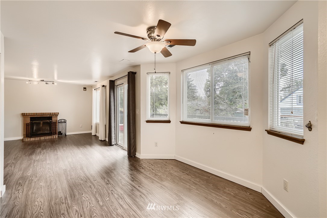 5445 17th Avenue Southwest Seattle, WA 98106 - Photo 4 of 19 a view of empty room with wooden floor and fan