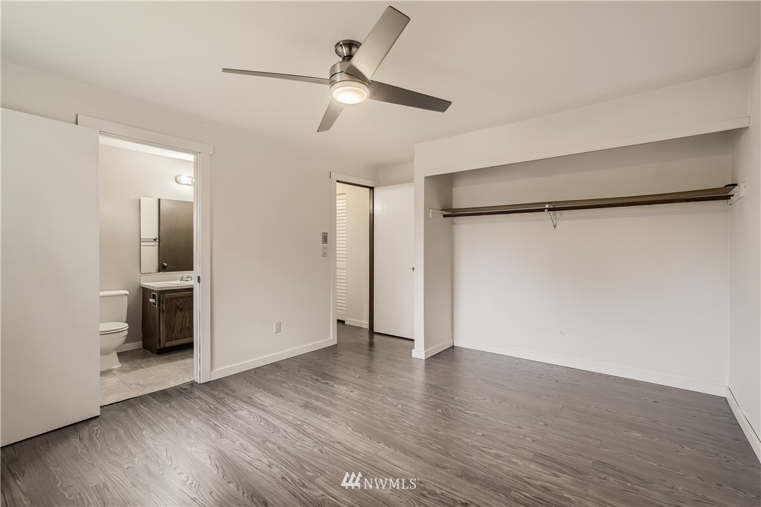 5445 17th Avenue Southwest Seattle, WA 98106 - Photo 8 of 19 a view of an empty room with wooden floor and a ceiling fan