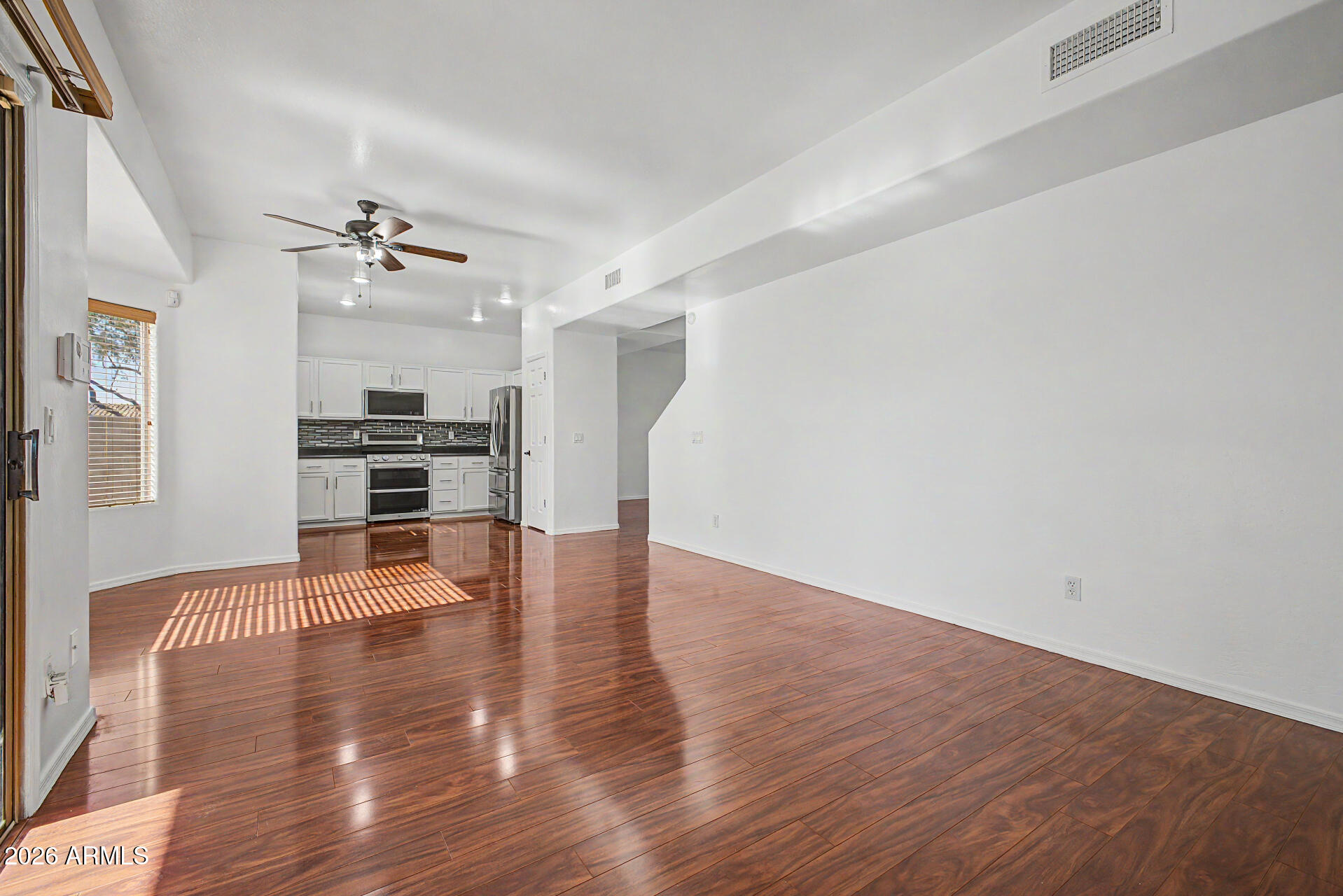 7206 South 12th Way Phoenix, AZ 85042 - Photo 8 of 34 a view of empty room with wooden floor