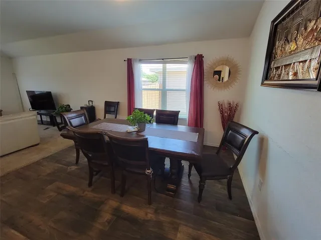 a view of a dining room with furniture and window