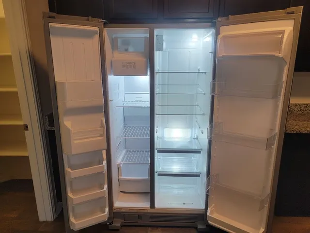 a bathroom with a glass shower door and mirror
