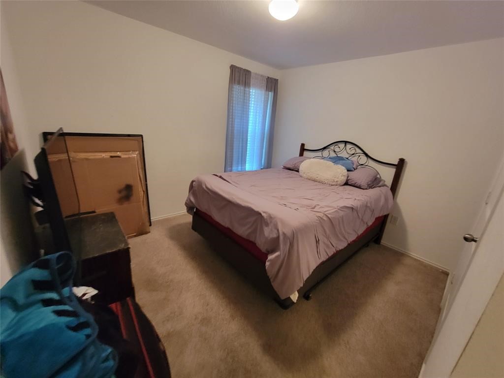 3610 Batson Drive Austin, TX 78725 - Photo 21 of 30 a bedroom with a bed and wooden floor