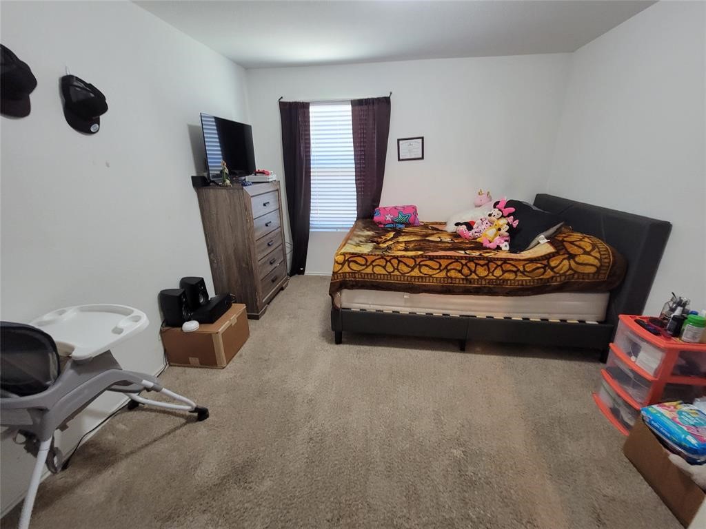 3610 Batson Drive Austin, TX 78725 - Photo 22 of 30 a bed room with furniture and a flat screen tv