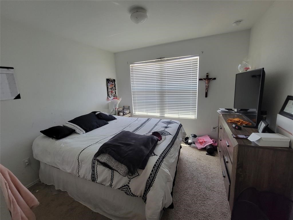 3610 Batson Drive Austin, TX 78725 - Photo 23 of 30 a bedroom with a bed and a desk