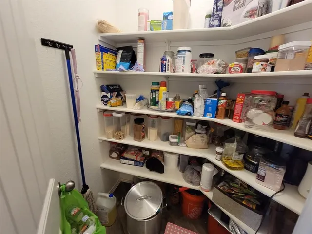 a room with a wooden floor and shelf