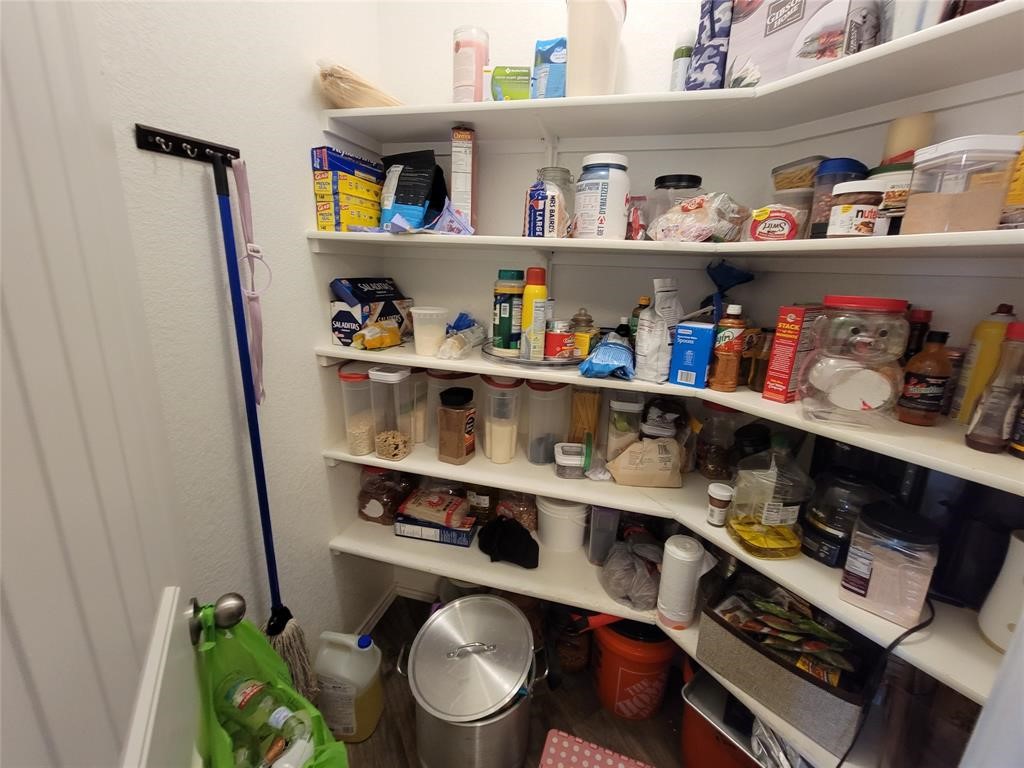 3610 Batson Drive Austin, TX 78725 - Photo 25 of 30 a room with a wooden floor and shelf