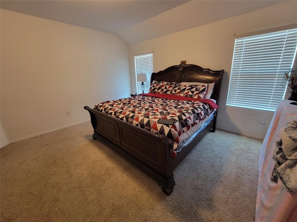 3610 Batson Drive Austin, TX 78725 - Photo 27 of 30 a bed sitting in a bedroom next to a window