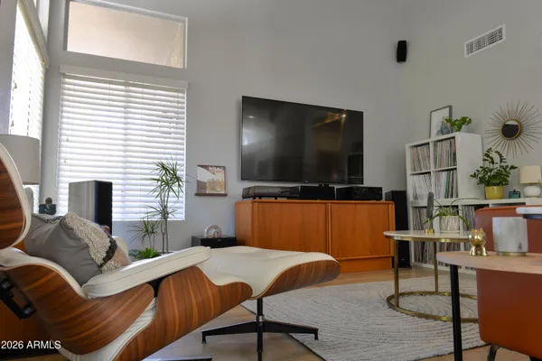 a view of a workspace with furniture and wooden floor
