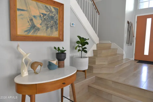 a bedroom with a bed and large windows