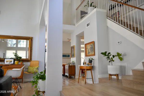 a living room with furniture chandelier and a flat screen tv