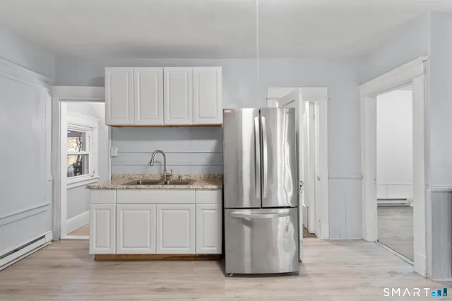 a kitchen with stainless steel appliances granite countertop a refrigerator sink and cabinets