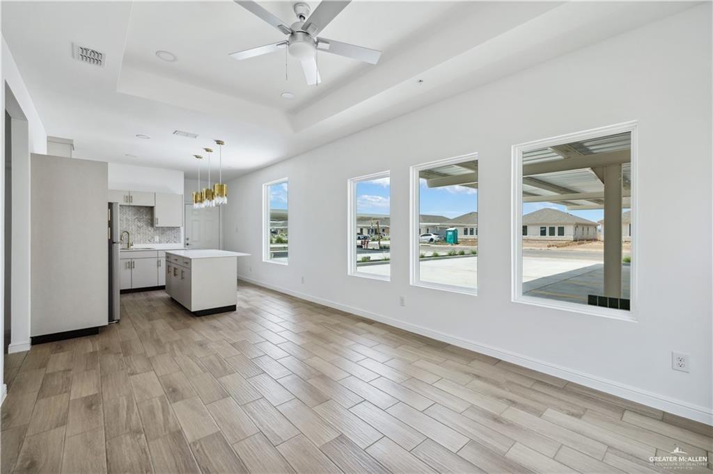 5323 Vision Street, Unit B Rio Grande City, TX 78582 - Photo 2 of 13 a view of a room with wooden floor and windows