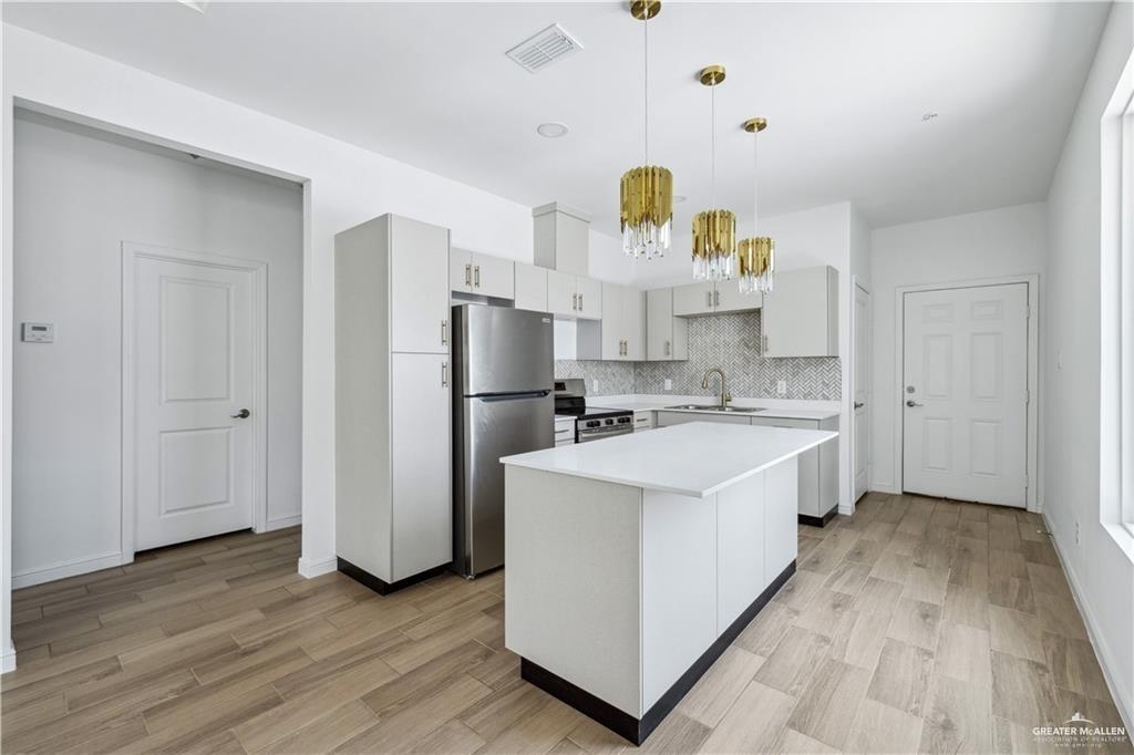 5323 Vision Street, Unit B Rio Grande City, TX 78582 - Photo 4 of 13 a view of kitchen with wooden floor and electronic appliances