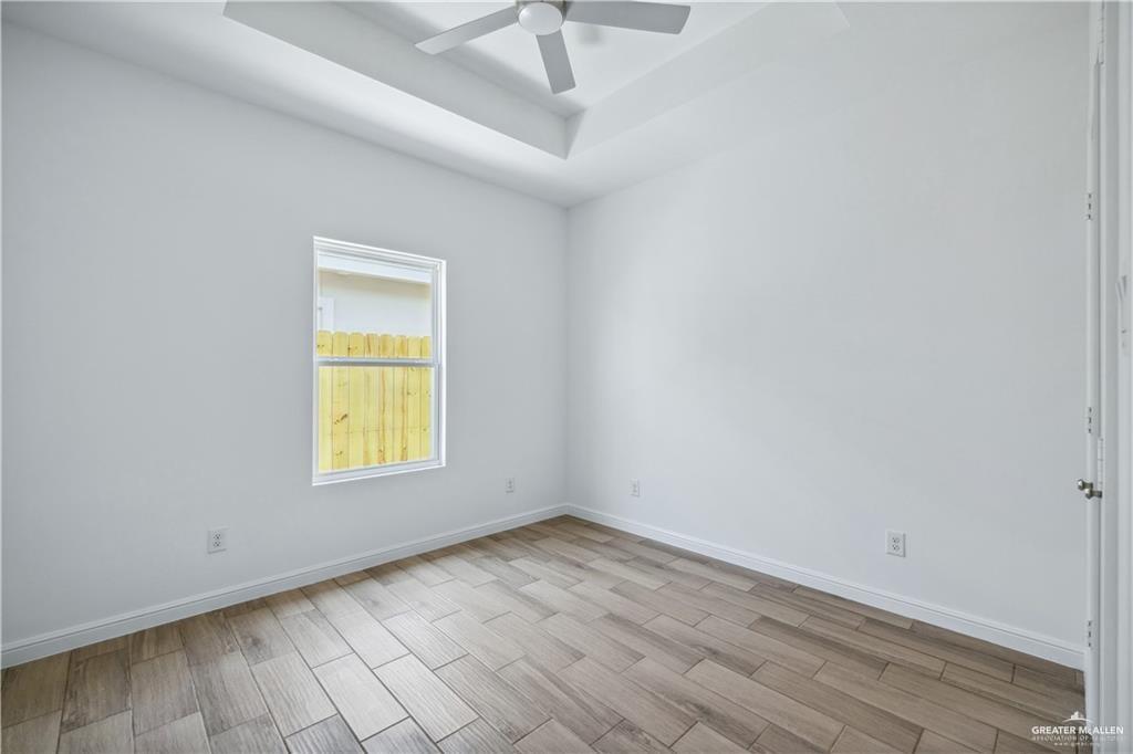 5323 Vision Street, Unit B Rio Grande City, TX 78582 - Photo 7 of 13 an empty room with a window and wooden floor