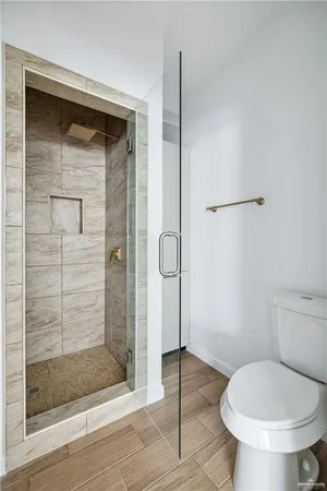 a bathroom with a toilet and a shower