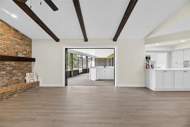 a view of a livingroom with an empty space and a fireplace