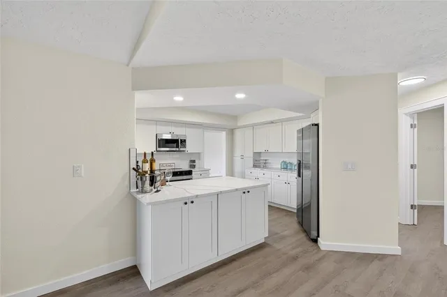 a kitchen with a sink and large window