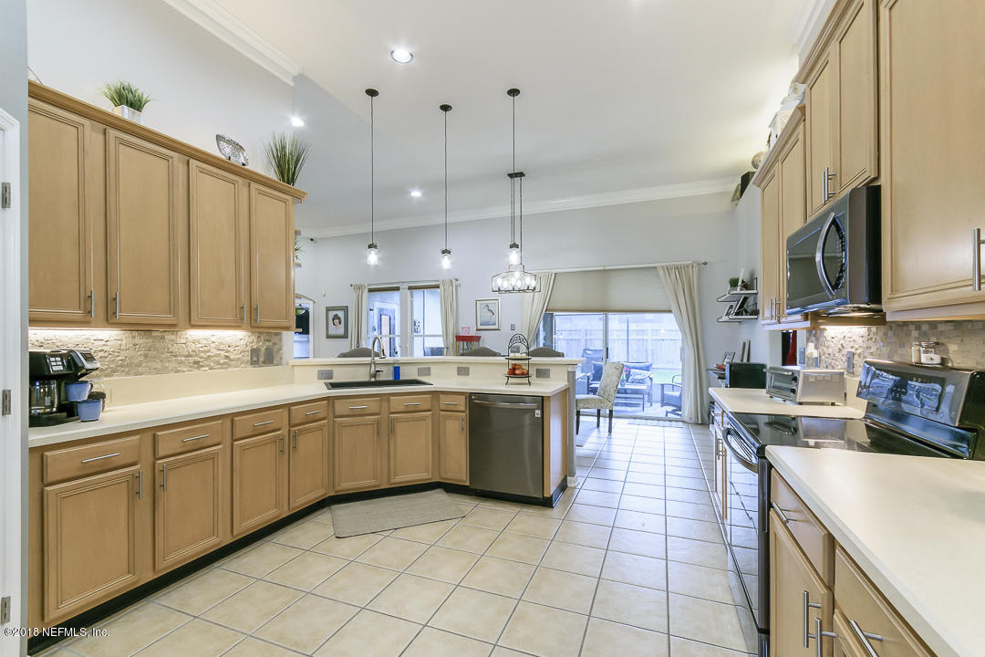 12171 Captiva Bluff Road Jacksonville, FL 32226 - Photo 11 of 36 a kitchen with a sink window and cabinets