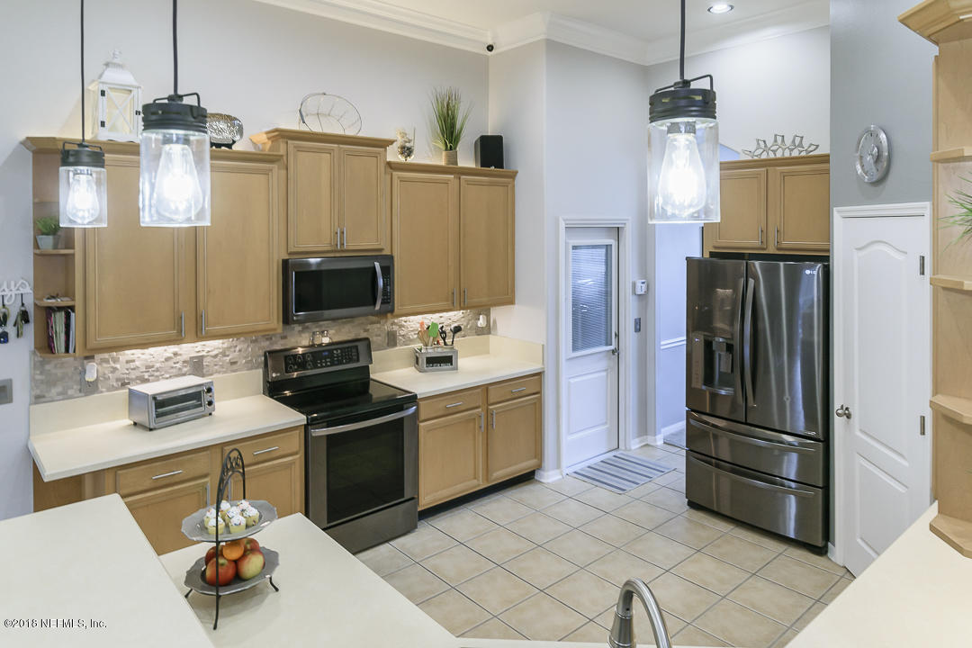 12171 Captiva Bluff Road Jacksonville, FL 32226 - Photo 12 of 36 a kitchen with stainless steel appliances granite countertop a refrigerator stove and microwave
