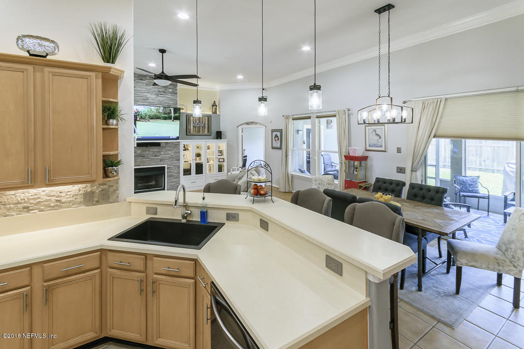 12171 Captiva Bluff Road Jacksonville, FL 32226 - Photo 13 of 36 a kitchen that has a lot of cabinets and a refrigerator