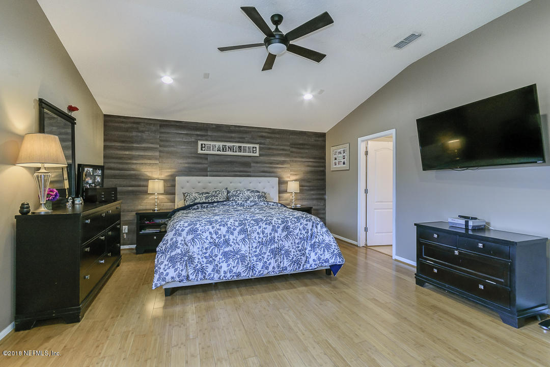 12171 Captiva Bluff Road Jacksonville, FL 32226 - Photo 16 of 36 a bedroom with a bed and a flat screen tv
