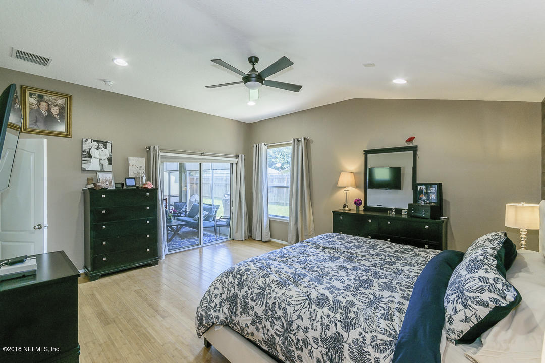 12171 Captiva Bluff Road Jacksonville, FL 32226 - Photo 17 of 36 a bedroom with a bed and a dresser
