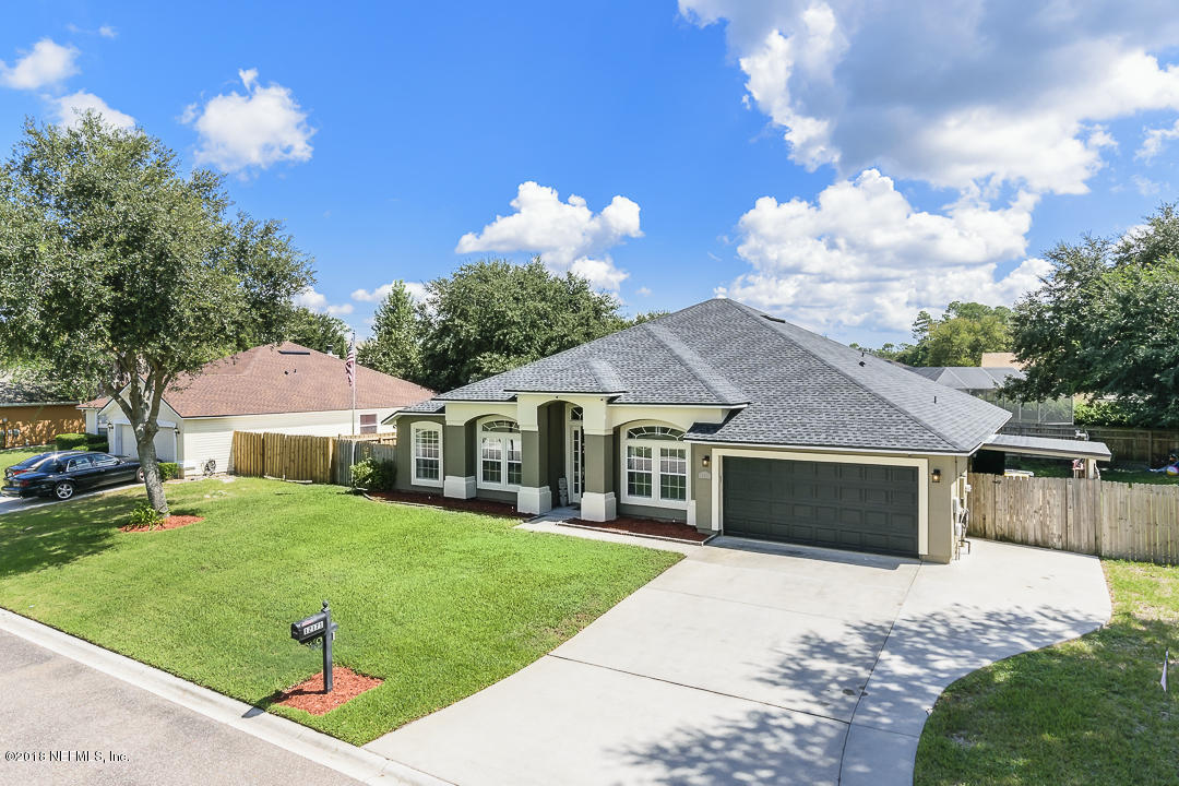 12171 Captiva Bluff Road Jacksonville, FL 32226 - Photo 2 of 36 a front view of a house with a yard and garage