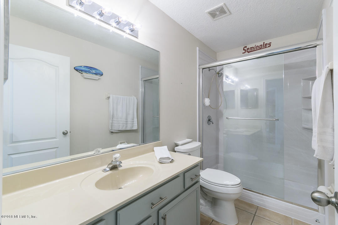 12171 Captiva Bluff Road Jacksonville, FL 32226 - Photo 21 of 36 a bathroom with a sink toilet a mirror and shower